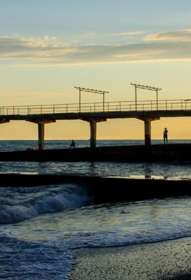 A coastal city dock A coastal city dock at the beach at sunset